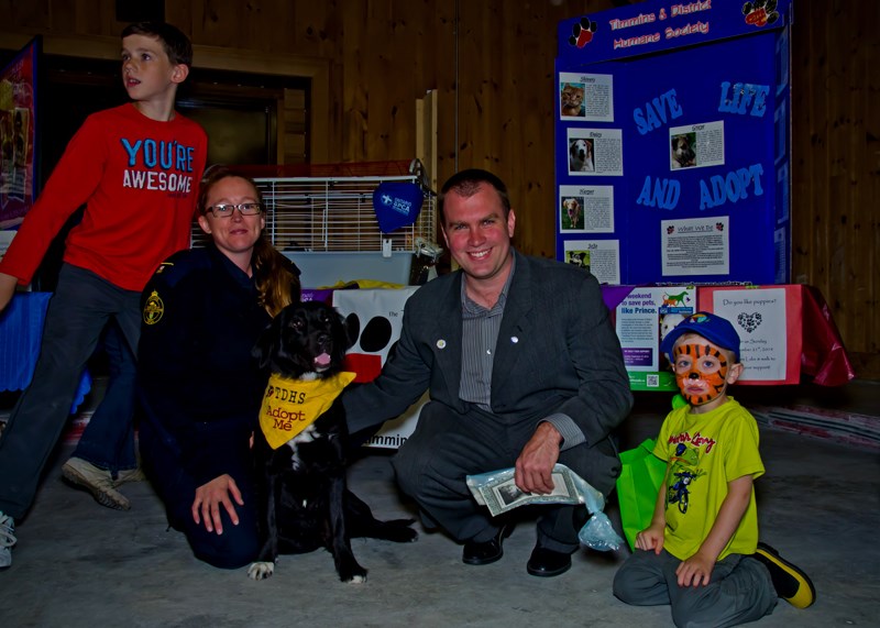 Timmins City Councilor Steve Black and his son Connor are photo-bombed with compliments as they join Christine Bradshaw of the Timmins District Humane Society to give Sally some love during the 21st Annual Welcome to Timmins Night.