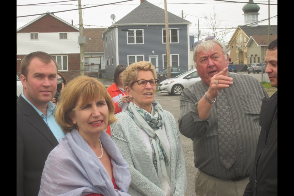 Ontario Premier Kathleen Wynne (centre) speaks with retired police officer Mickey Auger at the Timmins Native Friendship Centre. Mayor Steve Black (left) and Ottawa-Vanier MPP Nathalie Des Rosiers (front) were also on hand for a tour of the new housing facility on the property. Andrew Autio for TimminsToday                             