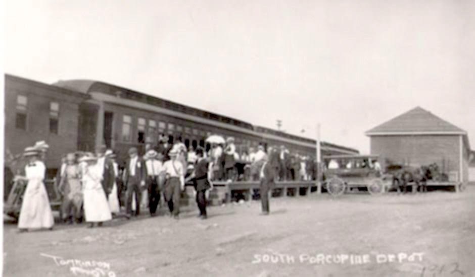 Passengers arrive at the station in South Porcupine in 1912. Note the horse-drawn taxi. 