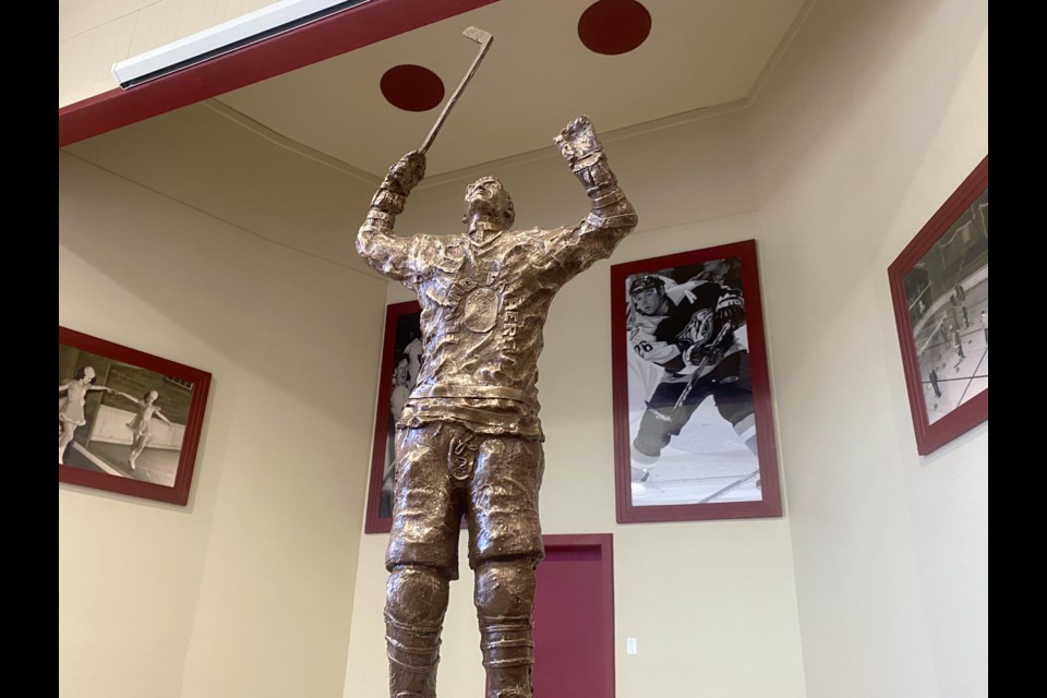 A 36-inch bronze Father Les Costello statue in the Timmins Sports Hall of Fame at the McIntyre Community Building.
