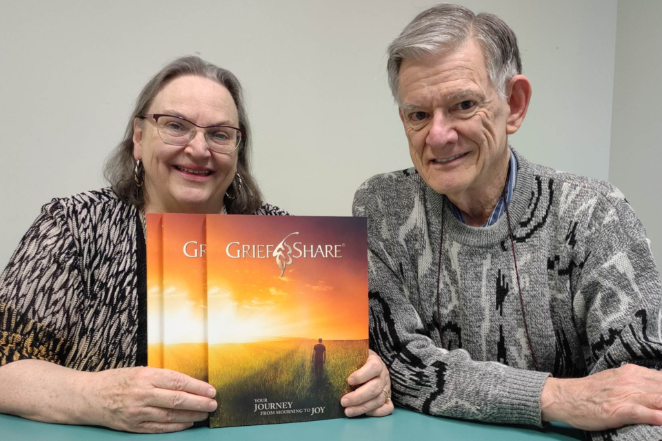 Peggy and Ted Bendell showing the guide book or as what they described as "homework" for people who wants to find joy after mourning with the death of a loved one.