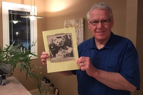 AJ Zimmerman holds a photo and newspaper clipping from 1990, the year the teddy bear program he established  first started. He has a binder full of clipping and photos taken over the years as donations were made by various organizations and individuals. Jessica Trudel for Timmins Today