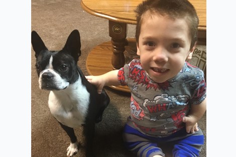 Robin Fortier, 6, lives with a condition called diastrophic dysplasia, also known as diastrophic dwarfism. He is 28 inches tall. Here, he poses with his cousin's dog Mia.