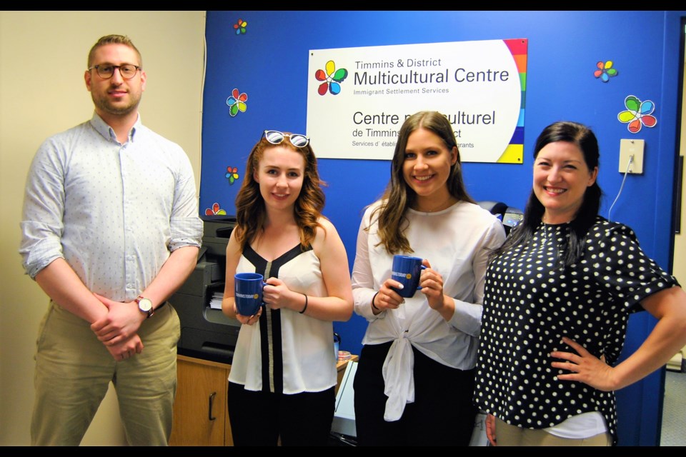 Timmins and District Multicultural Centre gets mugged with two Timminstoday.com mugs.  From left to right Tom Baby, executive director left, Nadia Picciotti, intern,  Brittany Pentland, and Chantal Boudreau. Frank Giorno for Timminstoday.