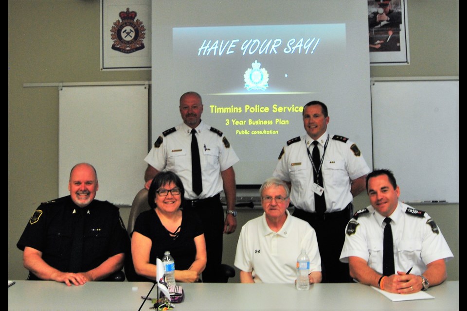 Timmins Police  Services Board presented the results  of a community survey on policing needs Monday night at a public meeting.  Police Chief John Gauthier (seated left) and TPS Board vice-Chair,   Darlene Lafontaine (2nd from left) , Board member Michael Doody and police team that oversaw the survey. Frank Giorno for TimminsToday.
