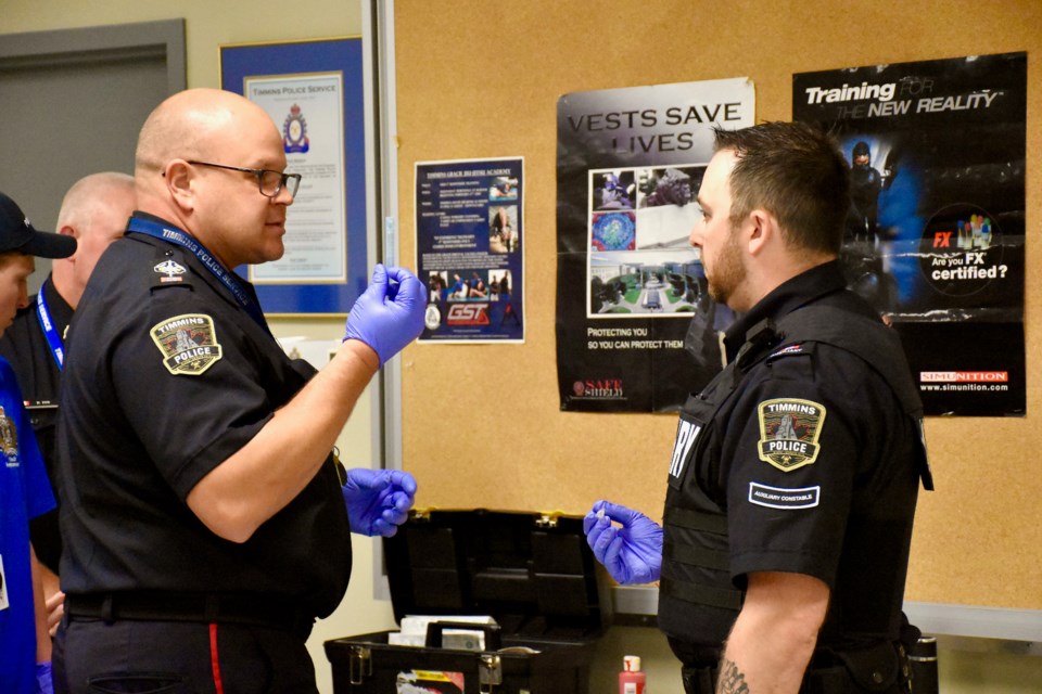 Timmins Police Const. Ryan Rantala, left, and auxiliary officer Jordan Guenette.