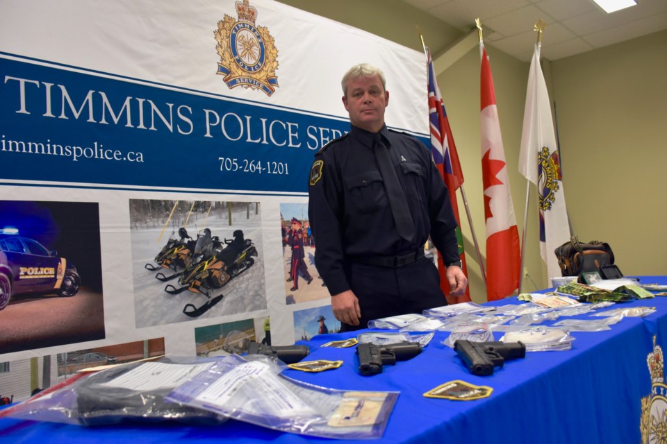 Timmins Police Staff Sgt. Mark Vallier with items seized by Timmins Police executing a search warrant at a Mountjoy Street North residence on Dec. 13, 2022.