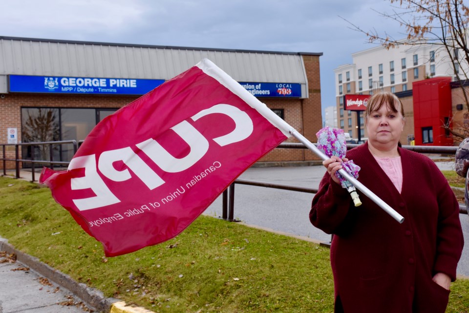 CUPE Local 8888 member Ginette Jalbert on the picket line in front of Timmins MPP George Pirie's office.