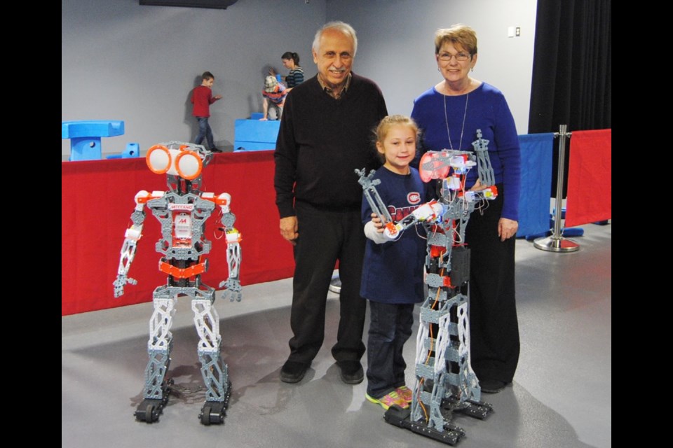 Programming Meccanoid the Robot. From left to right, Unnamed Robot, Antoine Grawal Science Timmins, Megan, Lorraine Cantin (Science Timmins) and Meccanoid the Robot.