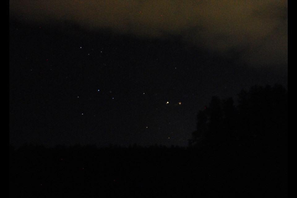 The Timmins Astronomy Clubs first  star party had partly cloudy skies, but the southwest sky was clear enough for Saturn to shine brightly. Saturn is the large, orange-ish light to the right by the darkened treeline. Photo: Frank Giorno, Timminstoday.com