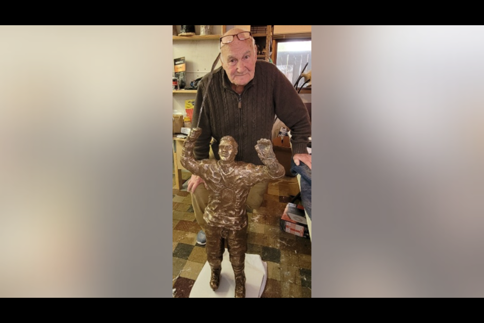 Former NHLer turned sculptor Gary Aldcorn with the bronze statue of Father Les Costello.