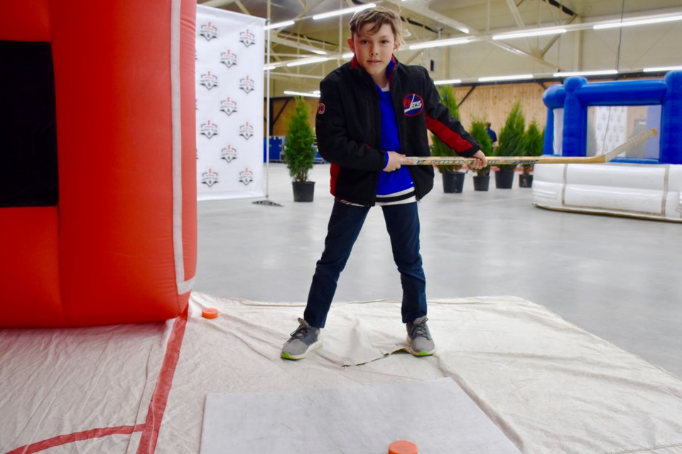John Mannila takes a shot at one of the games set up at the McIntyre Curling Club as part of the travelling Hockey Hall of Fame exhibit. Maija Hoggett/TimminsToday