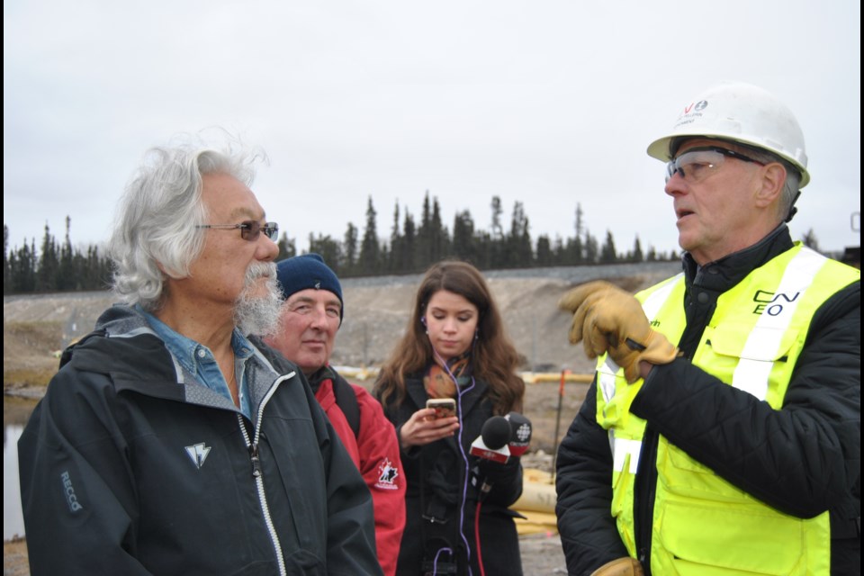 David Suzuki (left) and Norman Pellerin, a CN spokesperson dialogue about the severity of the oil spill into the Mattagami River near Gogama as a result of a CN train derailment. Frank Giorno for TimminsToday