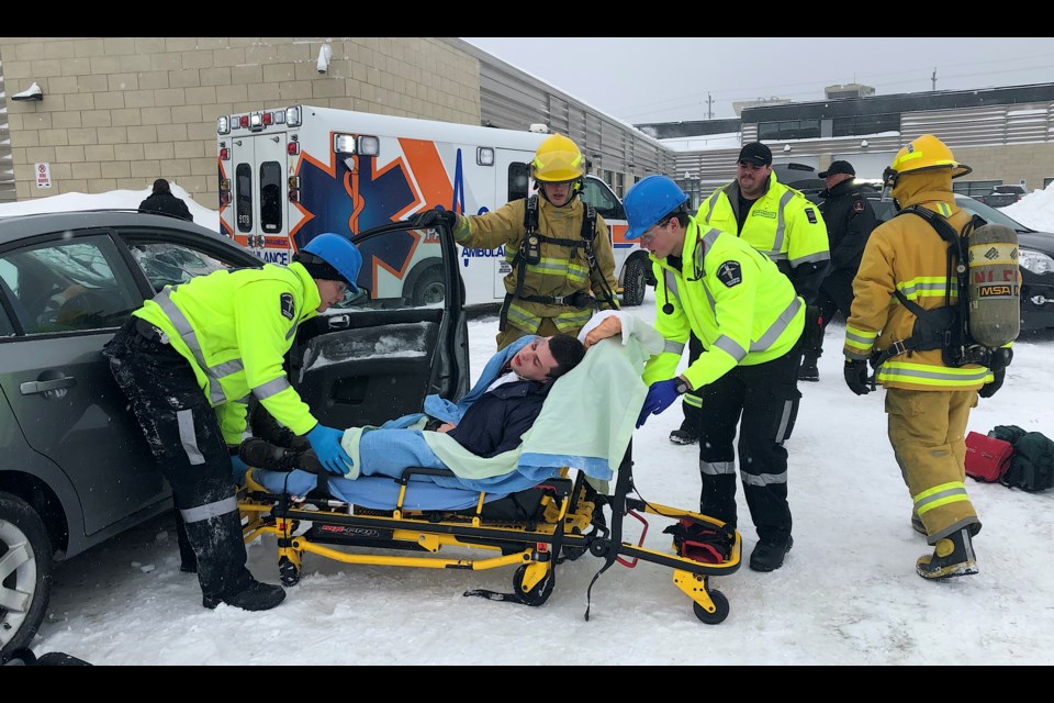 Preservice firefighter and paramedic students work to remove a crash victim from a vehicle during a mock disaster at Northern College. Wayne Snider for TimminsToday.