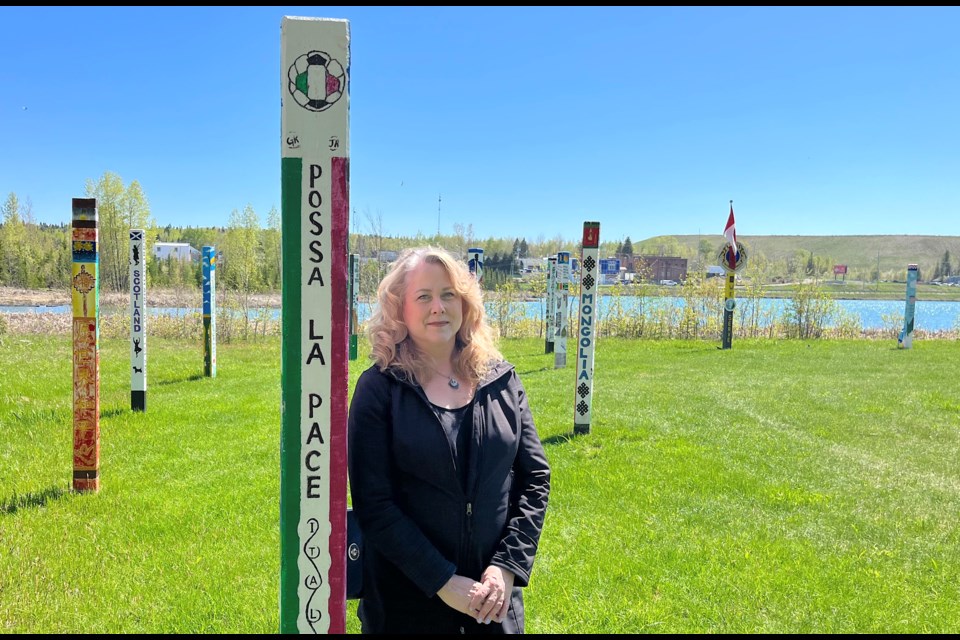 Marnie Lapierre, president and co-chair of the Timmins Multicultural Festival, enjoys summer-like weather at the International Peace Park Project in the Schumacher Lions Park, behind the McIntyre Arena. The Timmins Multicultural Festival returns to The Mac after a two-year absence due to the pandemic.