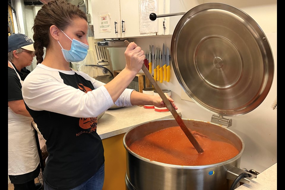 Krysta Kiraga, owner of Toffanello’s Fresh Pasta, stirs the sauce. Thirty gallons of sauce is made daily at Toffanello's. 