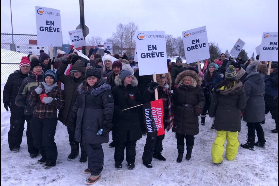 OSSTF teachers and supporters picket on the sidewalk in front of Ecole catholique secondaire Theriault. It was part of a one-day, province-wide strike after the union and Ontario government failed to reach an agreement by the midnight deadline. Wayne Snider for TimminsToday
