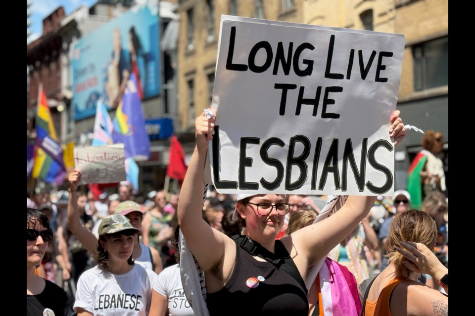 Attendees carried signs and cheered during Pride Toronto's Dyke Rally and March on June 28, 2025. 