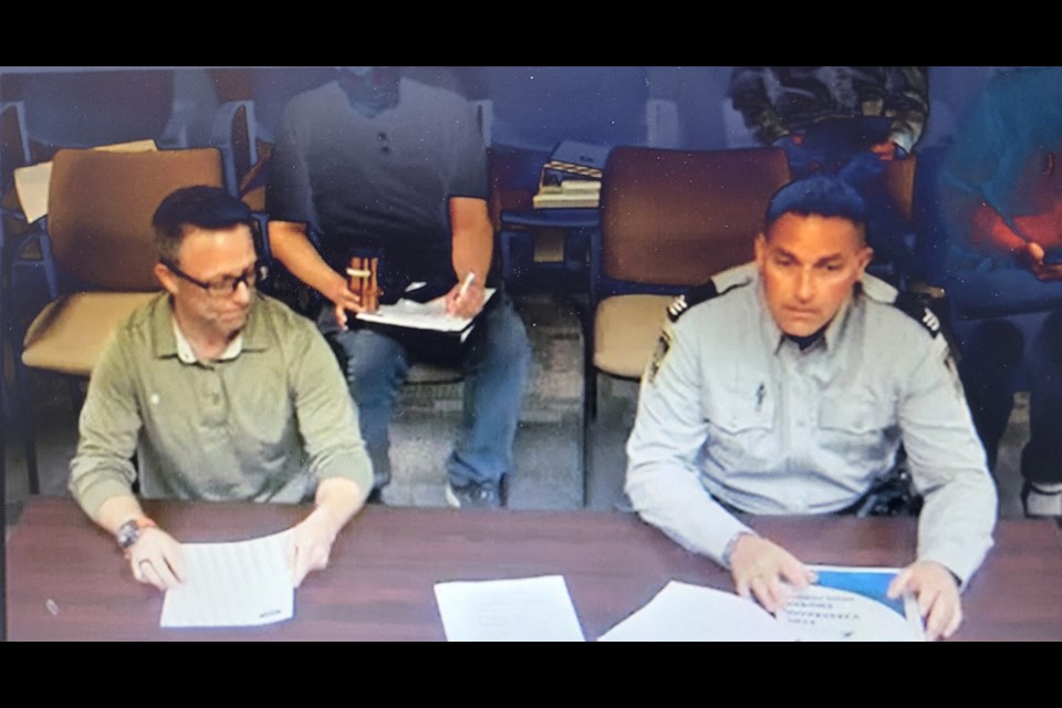 Sheldon Schoepp, Manager, Protective Services, for Woodlands County and Sargent Choma, Lac St Anne Enforcement Services peace officer present information at the Woodlands County Council meeting on Jun 19
