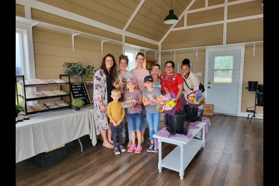 Vendors and Shoppers gathered for a moment at the Buttercream and Blooms event. Back L to R: Robyn Peters - Robyn's Bake House, Leanne Vanlaar, Amanda Kellner - Prairie Garden Floral Studio, Jamie-Lynn Vanleeuwen - JV Sweets, Ivonne Santos - Santos Kitchen, Aaliyah Froma. Front L-R; Chase, Jasmine and Skylar Vanlaar