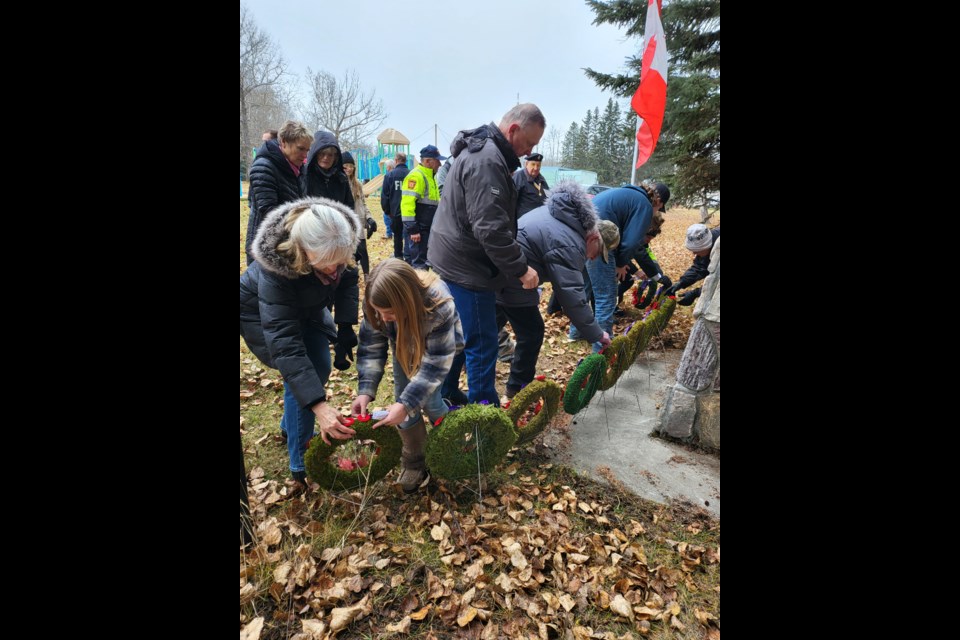 Remembrance Day services attendees in Jarvie on Nov. 11 placed poppies on the wreaths at the Jarvie Cenotaph. 