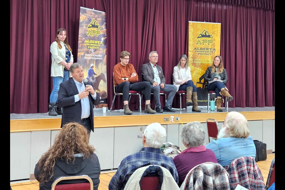 Athabasca-Barrhead-Westlock MLA Glenn van Dijken (left, on floor) shared a few opening remarks prior to the start of the Alberta Pension Plan: A start to sovereignty panel discussion March 6, at the Westlock Memorial Hall. The panel featured (seated on stage from left) economist Tanner Hnidey, financial planner Nadine Wellwood, author, media host and political advocate Cory Morgan and panel moderator and event co-ordinator Nicole Kimpton. Kristine Jean/WN  
