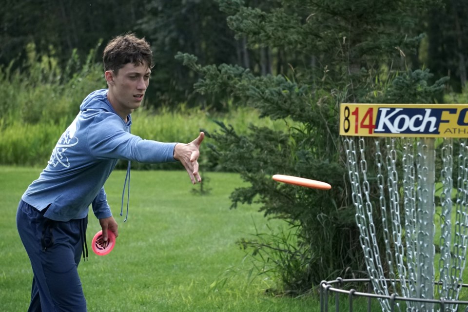 Twenty-five young athletes from across Alberta and B.C. gathered at Rocky Lane Fairways just south of Athabasca to compete in the second-annual ‘C’-tier Alberta Junior Disc Golf Championship Aug. 18-19. Nolan Litvak, 16, from Canmore, Alta. eyes the basket as he sinks his putt on hole 14 during the second round of play Aug. 19. Photos by Lexi Freehill/AA