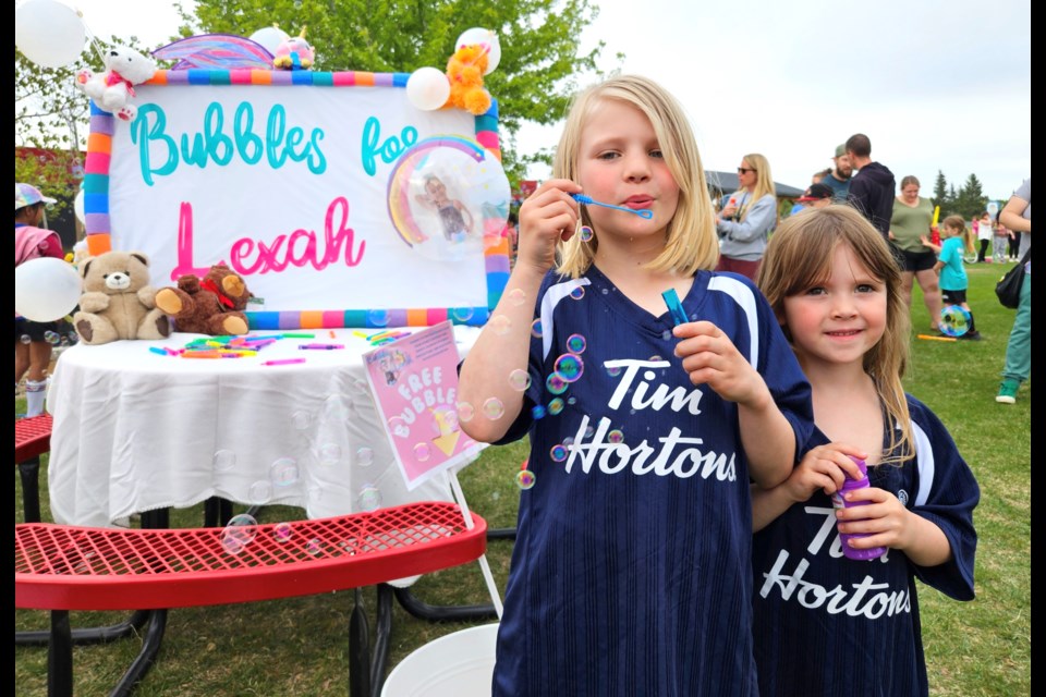 The Murphy sisters Keltie, left and Brooklynn, right, joined hundreds of Westlock and area residents and families May 28, at the Bubbles For Lexah event at Westlock Elementary School. Friends, family and members of the public gathered to blow bubbles for Lexah Makey, a five-year-old Westlock girl who was tragically killed in a car crash May 14. Kristine Jean/WN 