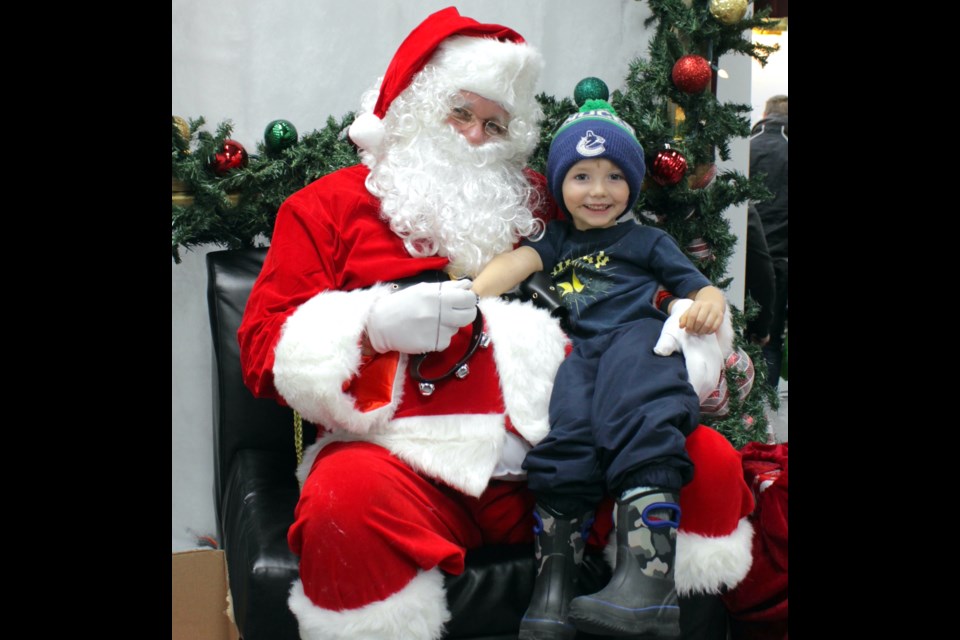 Westlock residents and families from across the region enjoyed the festivities at Westlock Memorial Hall Nov. 17 during the annual Christmas Light Up. The event featured games, activities, free hot chocolate and hot dogs and visits with Santa. Wyatt Miller of Westlock was one of several children to sit on Santa’s knee at the event. 