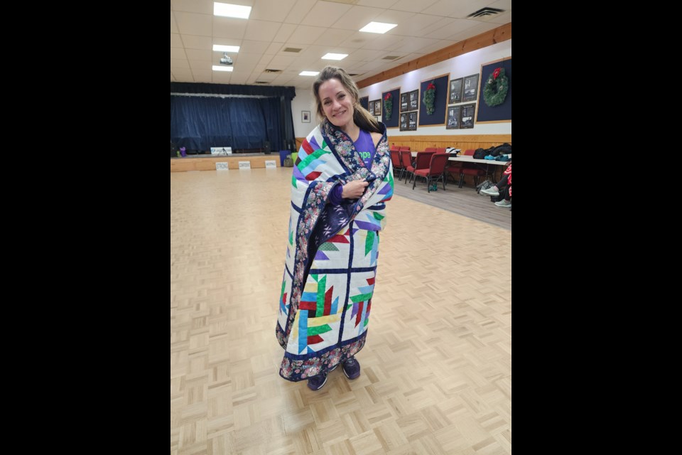 A beautiful quilt handmade by local artisan Glenda Polis was presented to Wiegand at the Dance 4 Hope fundraiser on Nov. 19. Photo provided by Sylvia Yoder.