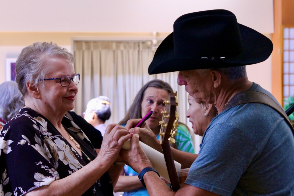 Danny Hooper signs a book on Prairie Country music stars in which he is featured in. 