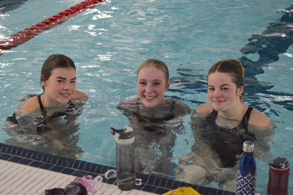 The first three swimmers to successfully complete their 200 laps from left Danica DeJong, Finley Ferguson and Bailey Smith. 