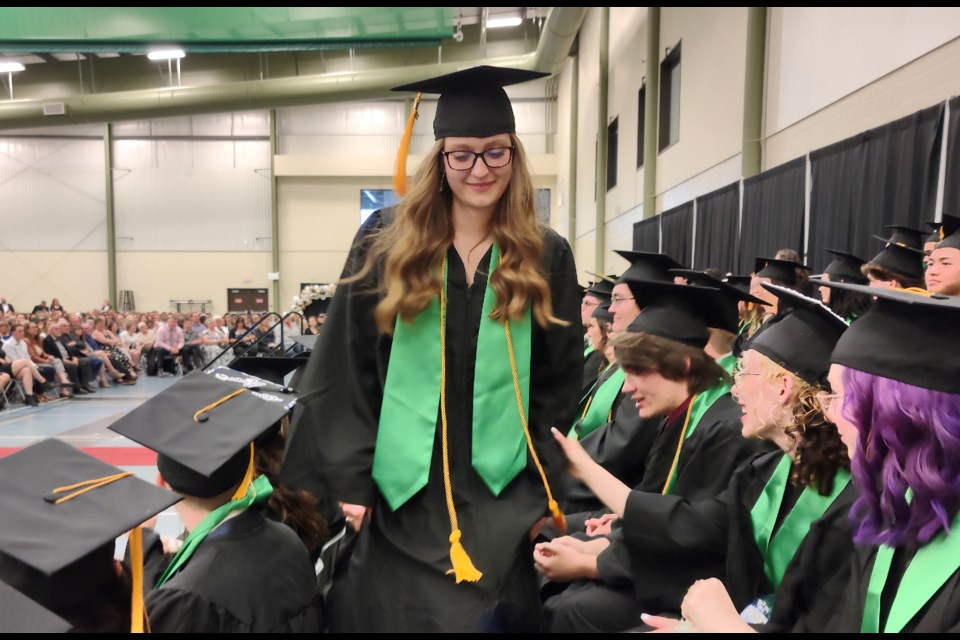 The Edwin Parr Composite graduating class of 2022 took their places on stage, together, May 28 — the first to do so in three years due to the COVID-19 pandemic. Ninety-four bright-eyed Grade 12 students were joined by friends, family, teachers and others to see them off into the world with love, support and encouragement, as well as sincere congratulations for their achievement. Several speakers, including Aspen View trustee Dennis MacNeil, Supt. Neil O’Shea and teacher Eziah Pahl did just that before grads received their diplomas and scholarships and awards were received. Valedictorian Hannah Grove returns to her seat after delivering her speech to the full house at the Multiplex.