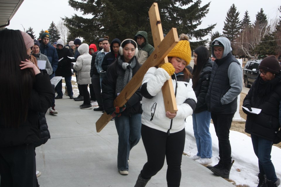 Parishioners with St. Mary of the Assumption Catholic Church carry a wooden cross down the ramp at the entrance of Parkview Plaza in Westlock as part of the annual Stations of the Cross devotion on the morning of Good Friday (March 29). The Stations of the Cross is a centuries-old tradition across the world where faithful walk a path symbolizing the journey of Jesus Christ on his way to the crucifixion. In Westlock, this annual tradition has been observed for many years, with local senior's centures and churches serving as the 14 stations. Parkview Plaza was one of the earliest stops.