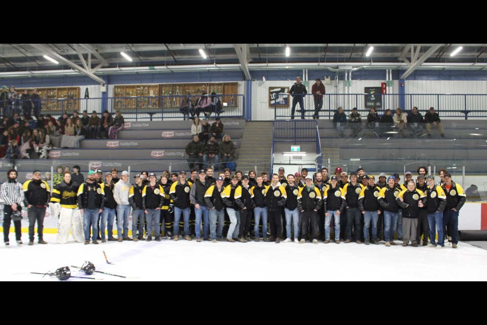 The current and past members of the Barrhead Steelers pose with Steve Bala during a special pregame Jan. 5 ceremony.