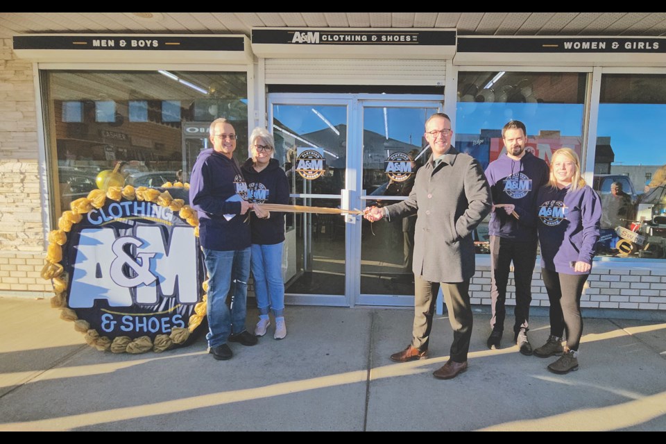 Members of the Arth family welcomed the Westlock and District Chamber of Commerce and members of the community for the ribbon cutting ceremony at A&M Clothing & Shoes grand opening on Friday, Oct. 20. Cutting the ribbon from left to right are: store owners Todd Arth and his wife Bonnie, Westlock and District Chamber of Commerce president Graeme Harrington, store manager Colton Arth and his wife Carley. 

Kristine Jean/WN