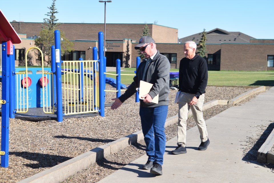 Town of Barrhead Coun. Anthony Oswald and Pembina Hills School Division Tracy Tyreman facilities director look at the accessibility challenges of one of Barrhead Elementary School's adventure playground.