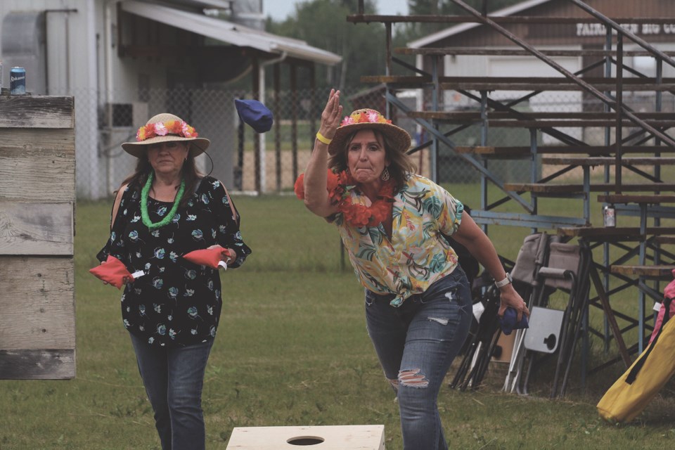 Karen Shaw and Karyn Harper got the weekend started early during the cornhole tournament at the Athabasca District Ag Society Summer Kickoff at the Athabasca Agriplex June 16.
