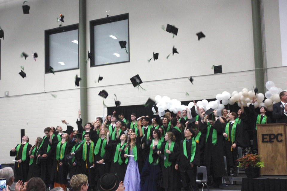 Students threw their graduation caps into the air in celebration as the ceremony ended.