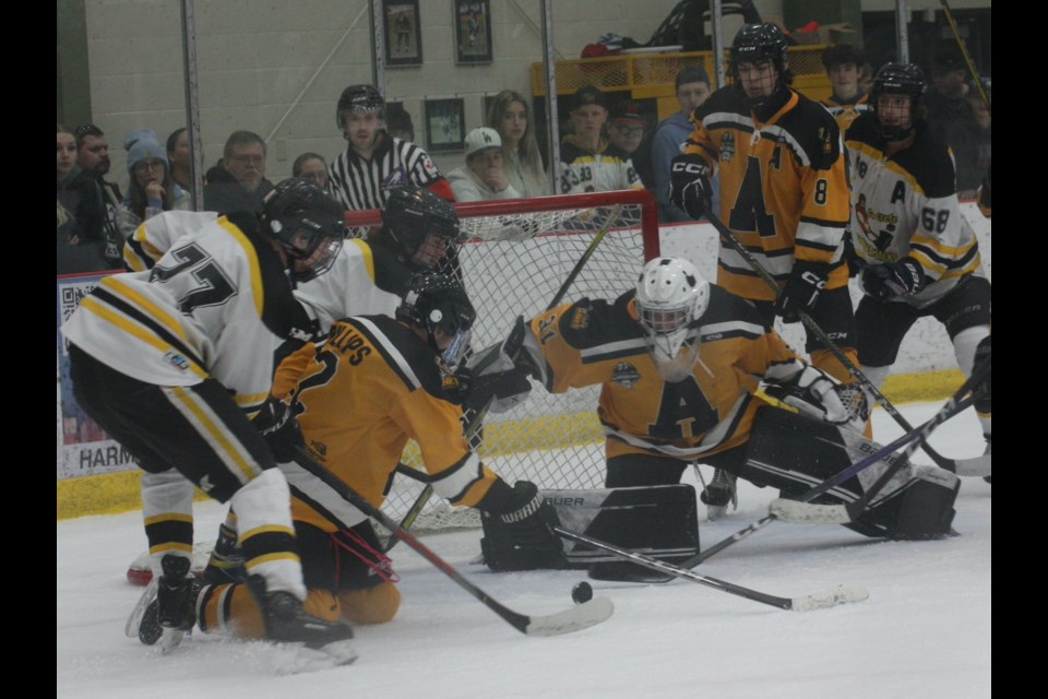 Athabasca U-18 Hawks goalie Bowie Loomis makes a save while teammates Brandon Phillips (left) and Rowan Ponich watch during the second period of the U18 Tier 2 Alberta Minor Hockey Provincial Championship final played April 2 in Athabasca. The Hawks stormed out to a 2-1 lead over the La Crete Lumberjacks but couldn’t hold on and fell 5-2 to finish with a silver medal.