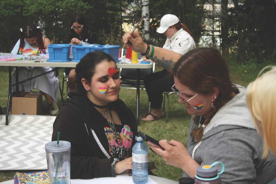 Face painting was one of the events during the Pride Family Picnic, held June 3 at the Athabasca United Church. Melissa Salamon adds some face paint to the stickers that Emmalynne Salamon was wearing as part of the festivities.