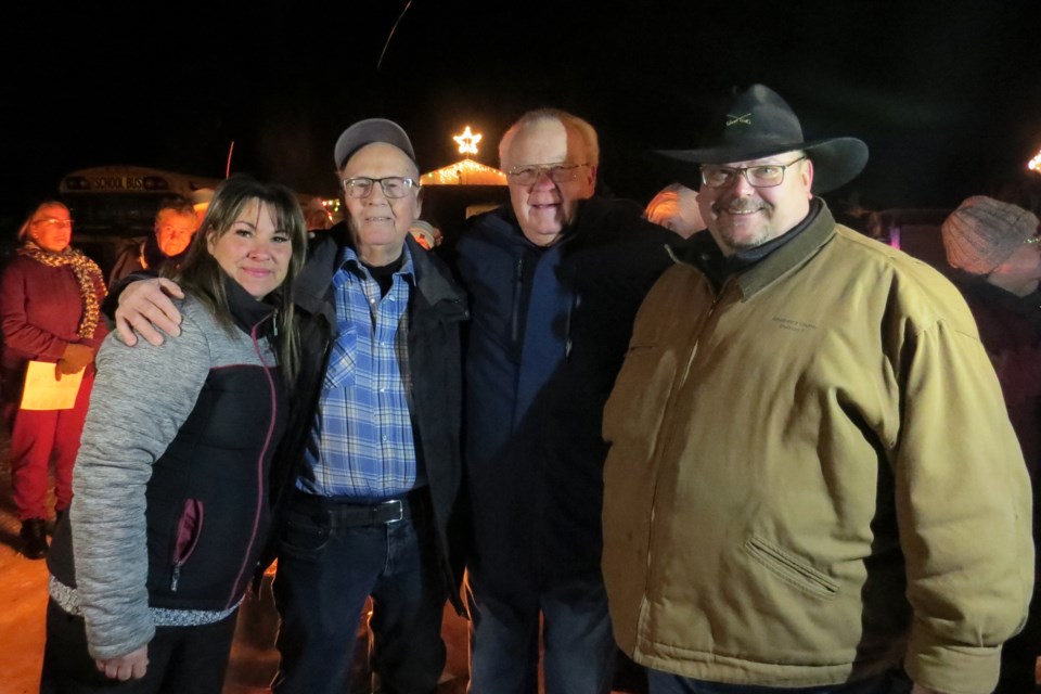 Members of the Grassland community surprised 85-year-old Hugh Witney at his property on Highway 63 Dec. 22 with a night of fellowship and caroling to honour his 40 years of putting up Christmas lights on his property. L-R: Athabasca County Ward 6 Coun. Penny Stewart, Hugh Witney, reeve Larry Armfelt and Ward 7 Coun. Travais Johnson.
Bryan Taylor/AA