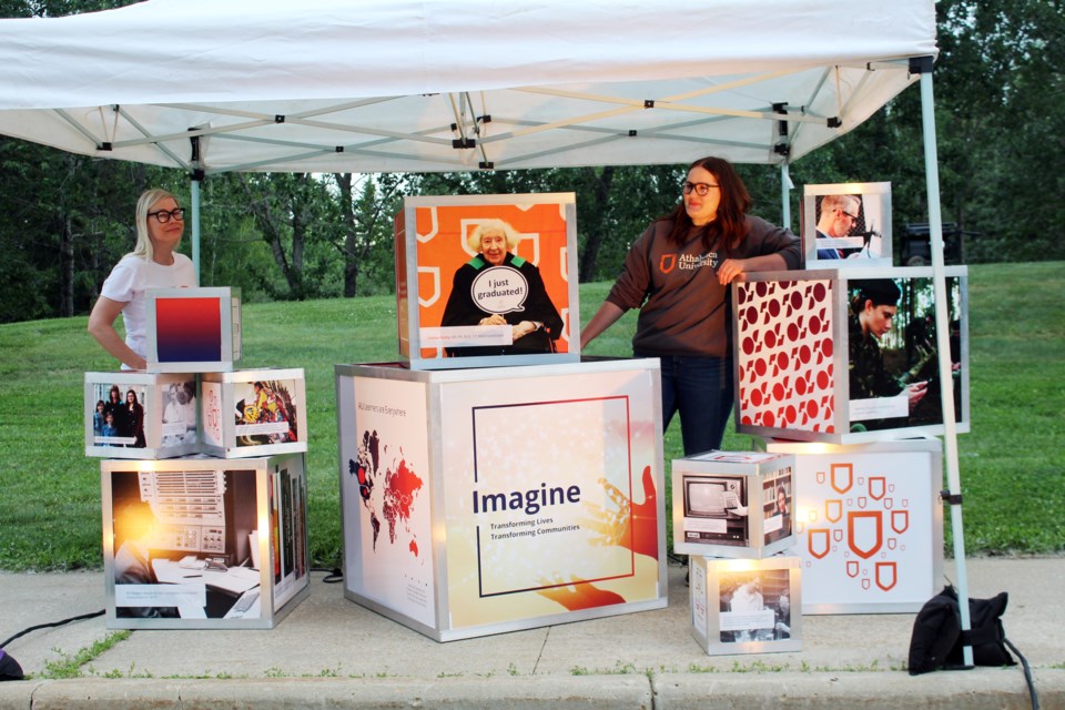 Angie Zander, AU director - communications and Lauren Mill do one last check before the cars drive by at the 50th anniversary of Athabasca University 'Light the Night' event on their campus June 25. This installation is a legacy piece that will be placed in a more permanent location.
Heather Stocking