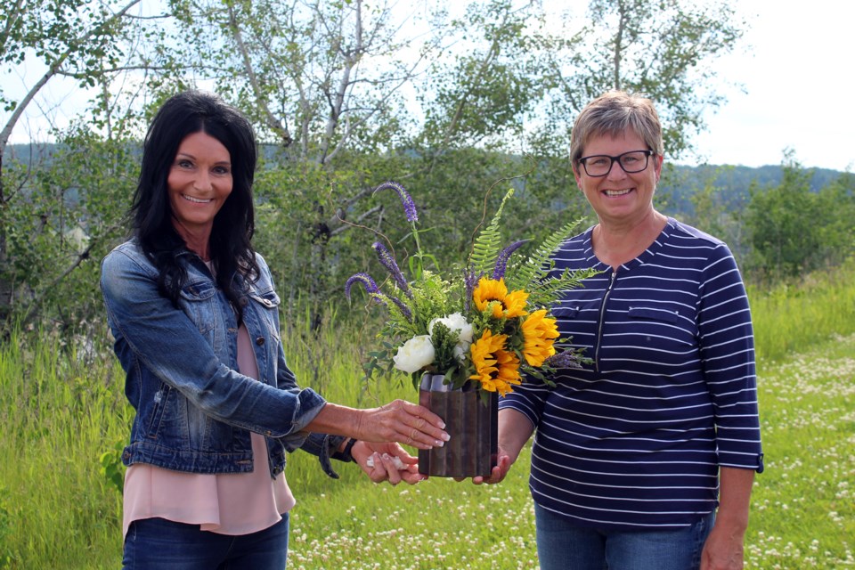 The drivers for Road to Hope threw a farewell party June 29 for co-organizer of the foundation and transportation coordinator Madena Reimer after her position was abruptly terminated. Kim LeMessurier (right) presented Reimer with a token of appreciation from the drivers for her 10 years of hard work.
Heather Stocking T&C