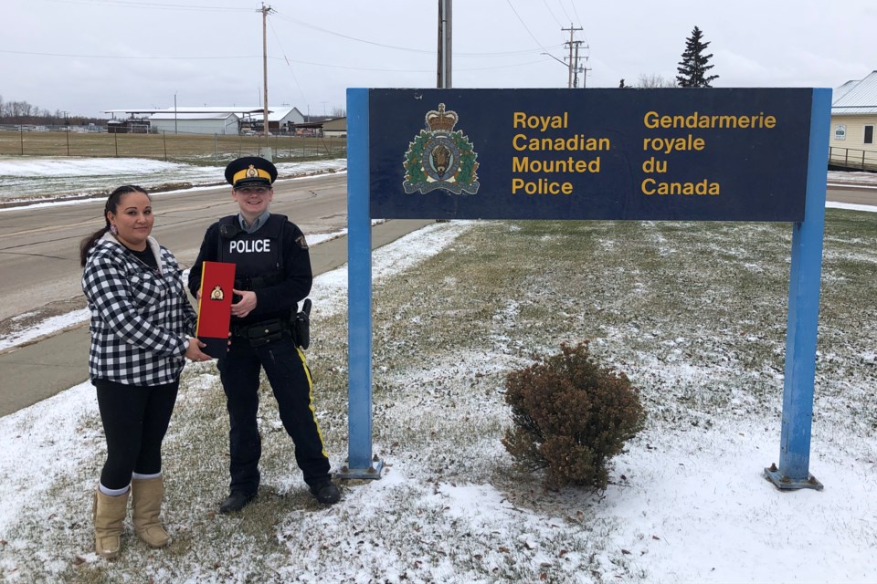 Shelley Anne Cardinal presented the eagle feather she beaded back to the Boyle RCMP Detachment Oct. 23. Const. Mel Shaw accepted the feather on behalf of the detachment.
Supplied 