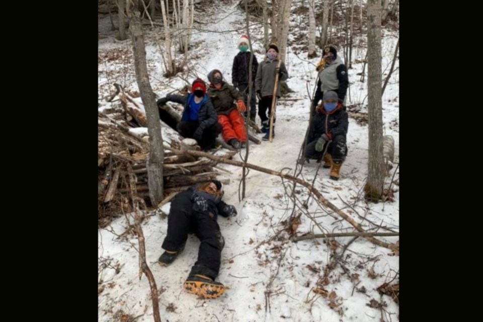 One of the groups take a break from building their fort as part of the LTIS Woodland Kids recess activity. Every school year students who participate not only build forts but elect a council to help mediate any conflicts between different fort groups. 

Clockwise from the bottom: Jake Robinson, Evan Liddell, Jasper Hynes, Joseph Seguin, William Allen, Sam Robinson, Andrew Kuzyk.
