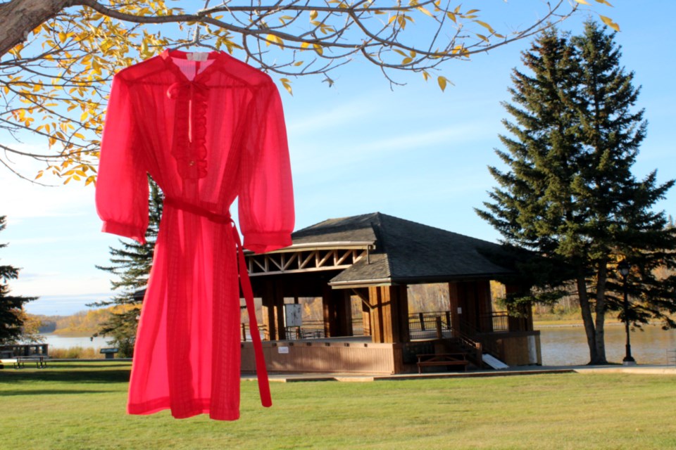 One of many red dresses the Athabasca Native Friendship Centre hung up around town and down a tree-lined sidewalk in memory of the thousands of missing and murdered Indigenous women, girls and two-spirit people. Over 50 people walked in memory of local Indigenous people who are a part of those numbers murdered or missing.