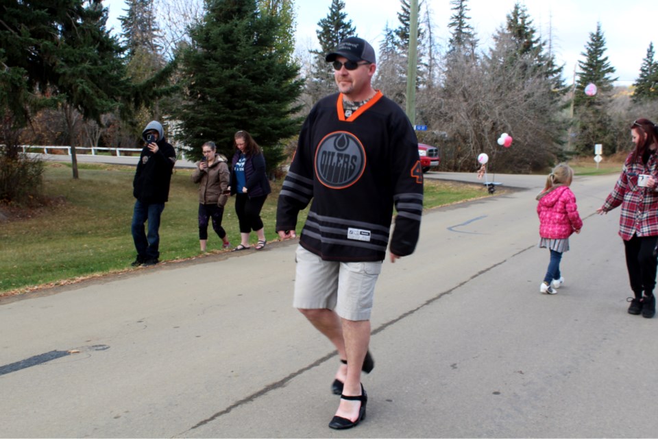 Russell Damon took a walk around Colinton Thanksgiving Day, Oct. 11, cheered on by family and friends, to work up an appetite and raise awareness about domestic violence wearing shoes his wife, Renee Nicholson, made for him. Damon signed up to help raise funds for PRAAC (Athabasca and Area Prevention of Relationship Abuse Action Committee). He walked the same route his daughter, 7-year-old Abby Damon, went only the week before raising money for the CBIC Run for the Cure.