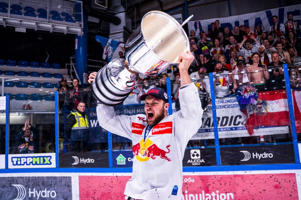 Keegan Kanzig, 27, who grew up in Athabasca, hoists the ICEHL (ICE Hockey League) cup over his head after his team, Red Bull Salzburg, beat out Hydro Fehérvár AV19, a Hungarian team, for the championship April 11.