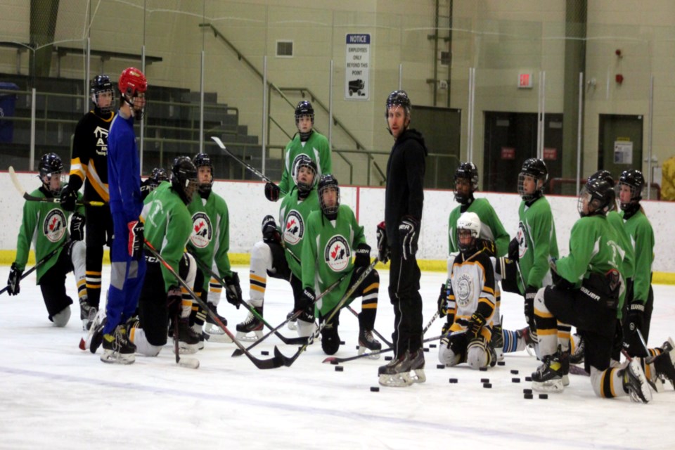 The Edwin Parr Composite (EPC) Hockey Academy students take a knee to listen to instructor, EPC teacher Derek West (centre, in black) who explains what drills they will be doing next. The program is part of Hockey Canada and focuses on building the skills in hockey players of all skill levels.
